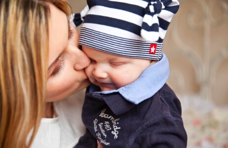 Mother and baby playing and smiling photo