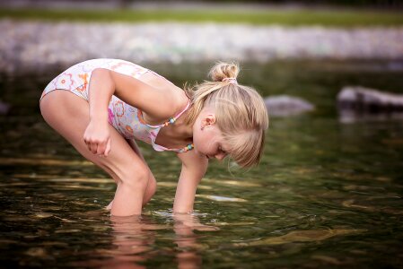 girl playing in outdoor swimming pool