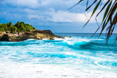 Waves on the ocean crashing on shore in Indonesia photo