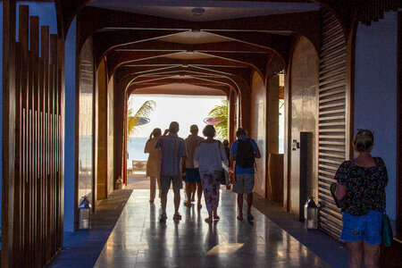 People Heading to the Beach Through a Passage