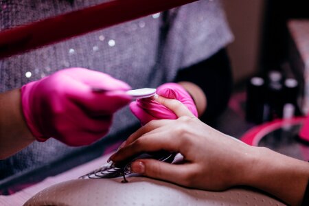 Woman Hands Receiving Manicure And Nail Care Procedure photo
