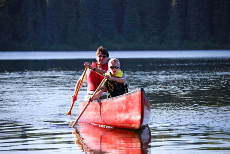 Man and boy paddle a canoe-4 photo