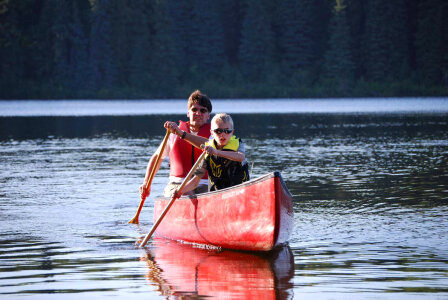 Man and boy paddle a canoe-4