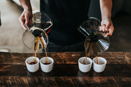 Professional Barista Serves Hand Brewed Coffee photo