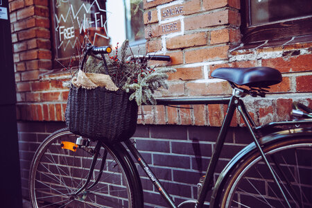 City Bicycle with Basket in Front of the Old Brick Wall photo