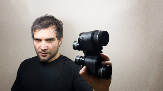 young man with binoculars photo