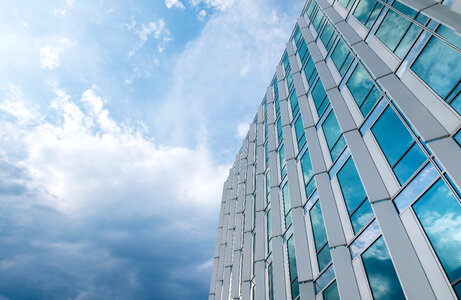 Amazing office building with windows. Blue sky with clouds after rain photo