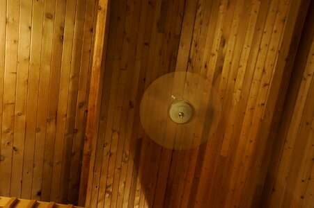 Wooden ceiling, white fan spins quickly