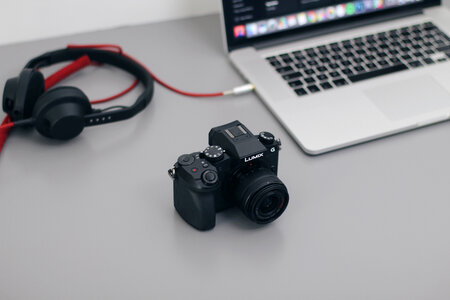 DSLR Camera, MacBook and Headphones photo