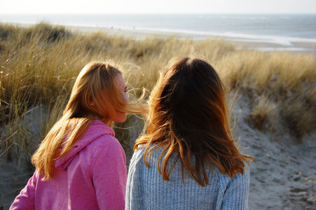 Two Girls Sitting on the Dune photo