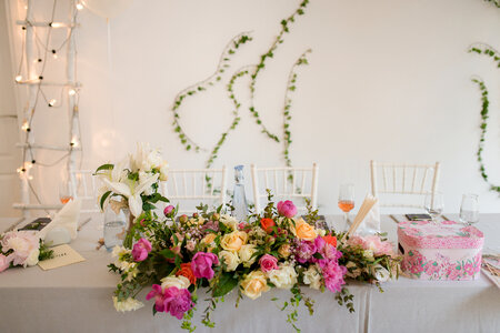 Bride and Groom Table Decorated with Flowers photo
