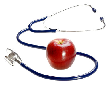 Stethoscope and Apple on White Background photo