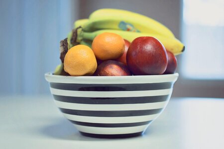 Striped Fruit Bowl with Apples, Bananas & Oranges photo