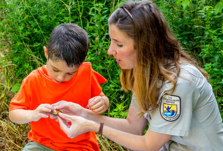 FWS employee and little boy look at tagged monarch-1