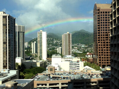 Rainbow over city buildings in Honolulu, Hawaii photo