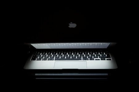 Silver laptop on a black background photo