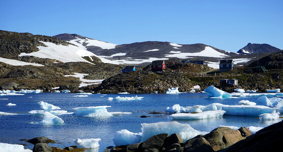 Landscape with hills and lake and ice and house in Greenland photo