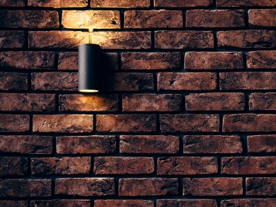Old rough brick wall background texture with a spotlight photo