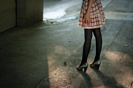 Female Legs And A Dress Standing Outside photo