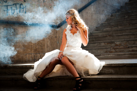 Woman Wearing White Wedding Dress Sitting on Stair photo