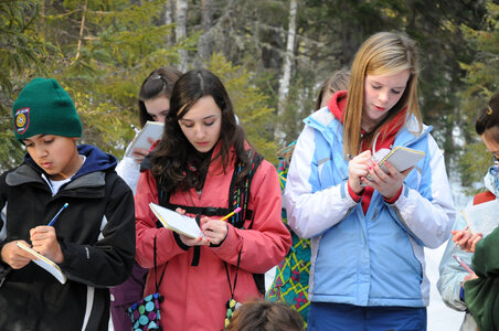 Youth writing in a nature journal photo