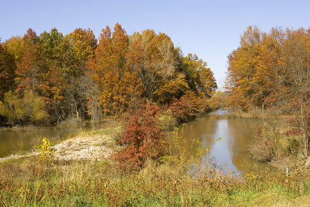 Water control dam and autumn trees photo