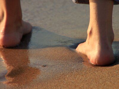 Girl’s Barefoot Legs on the Beach photo