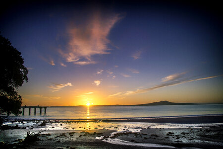 Sunrise on the beach in Auckland, New Zealand photo
