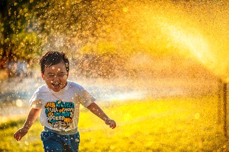 Happy Boy Running, Water Spray photo