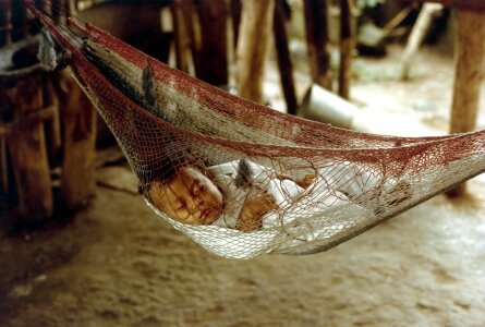 Baby sleeping peacefully in striped sling as hammock photo