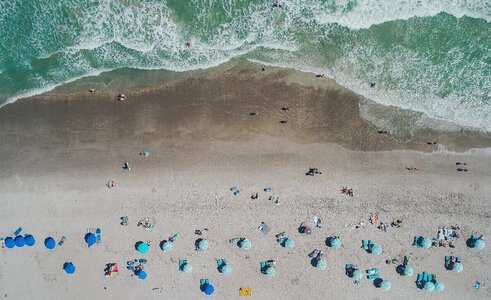 Aerial View of Sandy Beach with Tourists photo