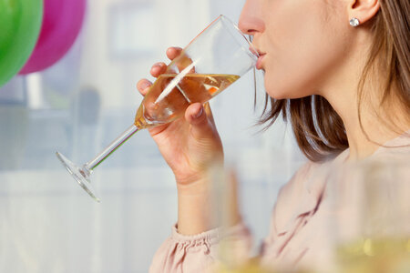 Girl drinking a glass of champagne photo