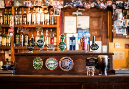 Beer flight of eight sampling glasses of craft beer on a bar coun photo