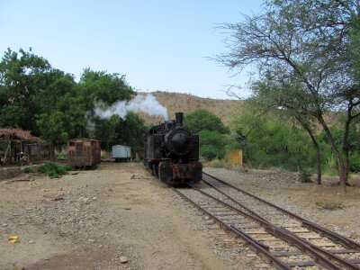 Old retro steam train stopped at the small station photo