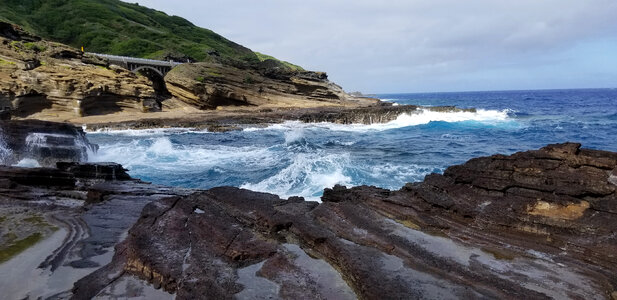 Large Waves crashing on rocks with shoreline landscape photo