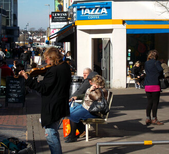 man busker playing violin on the street photo