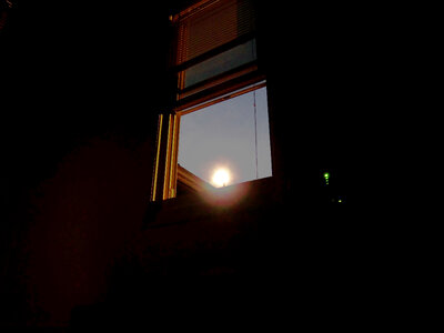 Moon shine through a window photo