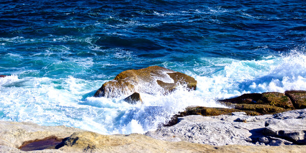 Small wave crash against the rocks photo