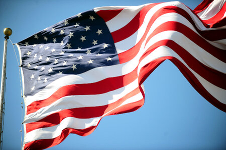 a waving USA flag. Blue sky background
