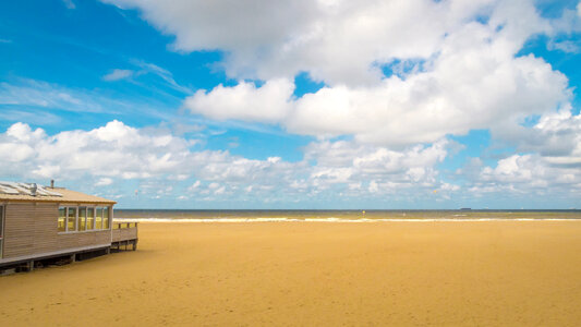 Beautiful beach landscape under the sky and clouds in The Hague, Netherlands photo
