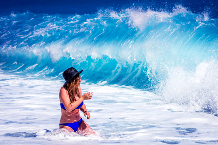 Wet Woman in Blue Bikini at the Sea and Splash of Waves photo