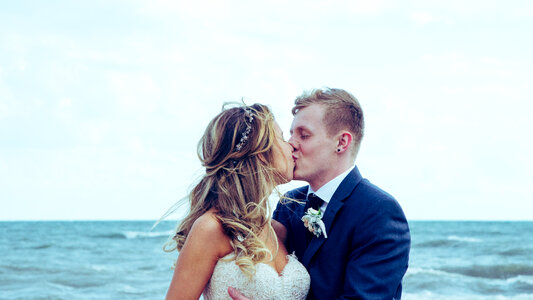 Wedding Couple Kissing on the Beach photo