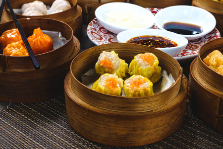 Chinese steamed and fried dim sum in wooden steamers photo