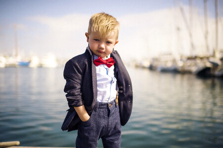 Little Boy Wearing Elegant Jacket with Red Bow Tie photo