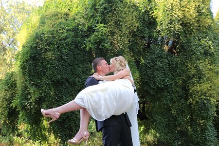 Groom holding bride photo