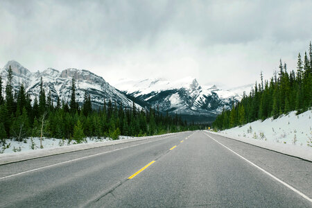 Road with snow-capped mountains with trees and landscape in Jasper National Park, Alberta, Canada photo