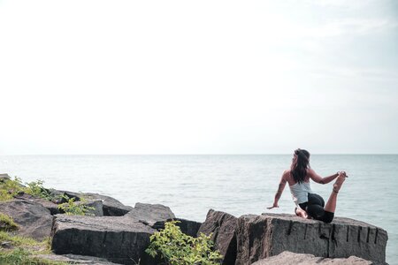 Woman Does Yoga By The Water photo