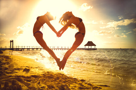 girls-jumping-to-make-a-heart photo