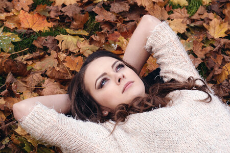 Beautiful Girl Lying on Fall Leaves photo