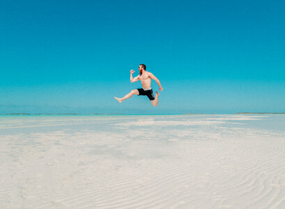 Happy Man Jumping on the Beach photo